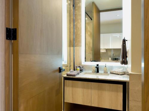 a bathroom with a sink and a mirror at Casa La Aurora - Beachfront Studio and Rooftop Infinity Pool in Puerto Morelos