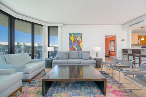 a living room with couches and a coffee table at Phoenix on the Bay 1528 in Orange Beach