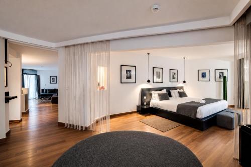 a bedroom with a bed and a living room at BAB HOTEL Marrakech, Boutique Hôtel & SPA in Marrakesh