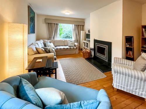 a living room with a couch and a fireplace at Garden View Cottage - Uk50886 in Cupar