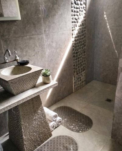 a bathroom with a sink and a shower at Tiny Black Loft in Port Vila
