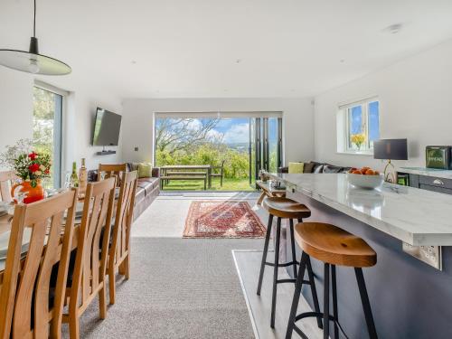 a kitchen and living room with a counter and chairs at Trafalgar - Uk44982 in Newport