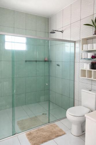 a bathroom with a glass shower with a toilet at Casa privada 3 quartos próx aos canyos in Piranhas