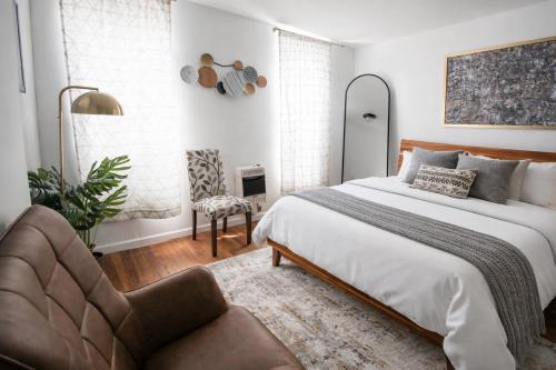 a bedroom with a bed and a chair at Hoboken Studio 15 Min from Manhattan in Hoboken