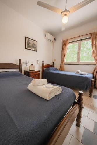 a bedroom with two beds and a window at Hotel Centro SJ in Villa Carlos Paz