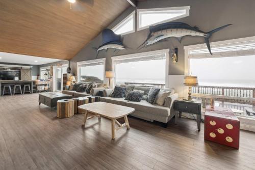 a living room with a couch and sharks on the wall at Neptune's Watch in Gleneden Beach