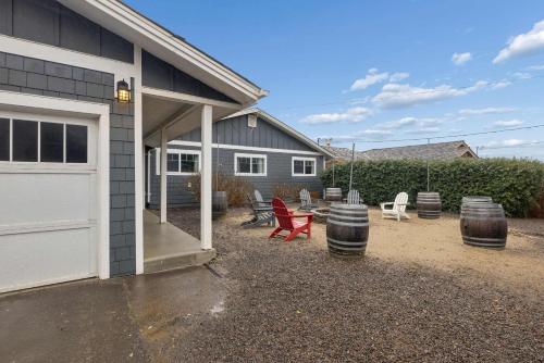 a house with a garage and some chairs and barrels at Neptune's Watch in Gleneden Beach