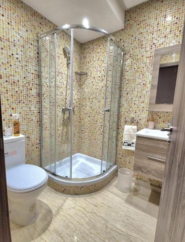 a bathroom with a shower with a toilet and a sink at CaSa FAMILY HOUSE in Casablanca