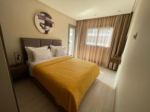 a bedroom with a bed with a yellow blanket at CaSa FAMILY HOUSE in Casablanca