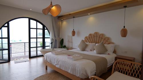 a bedroom with a large bed and a tub in it at Koh Rong New Beach Resort in Koh Rong Island