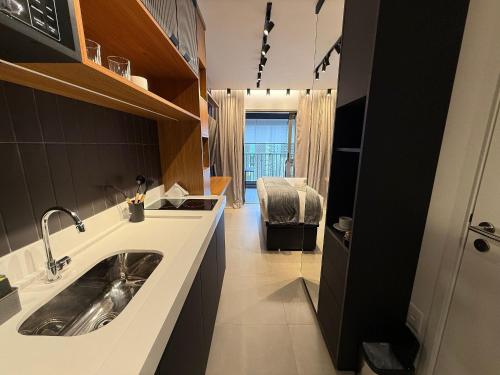 a kitchen with a sink and a counter top at On Jurupis - Livinn by Travel Inn OJ1 in São Paulo