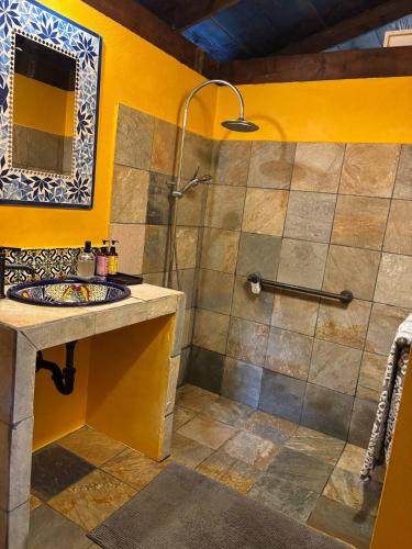 a bathroom with a shower and a sink at My Mountain Home - Le Chalet in Afaahiti