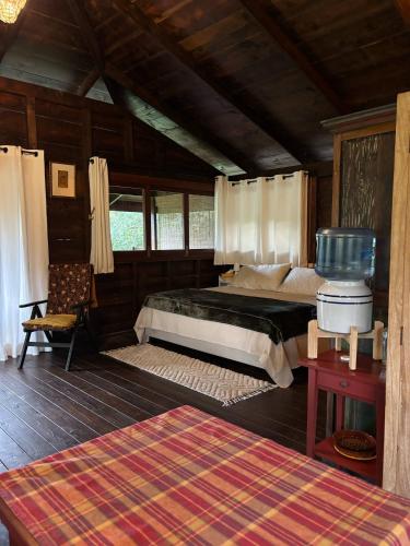 a bedroom with a large bed in a room at My Mountain Home - Le Chalet in Afaahiti