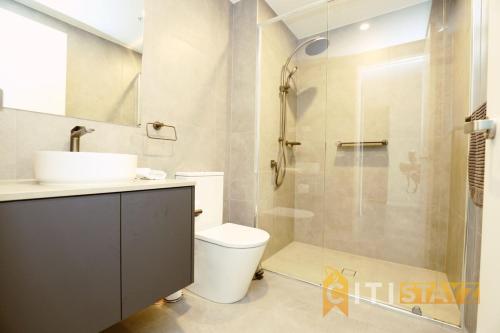 a bathroom with a shower and a toilet and a sink at Lovely in Lyneham - 1bd 1bth Apt in Canberra