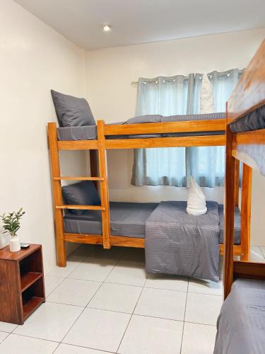 a room with two bunk beds and a table at Lio house in El Nido