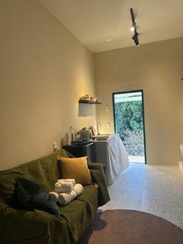 a living room with a couch and a table at Gác Homestay Phan Thiết in Ấp Sung Xuân