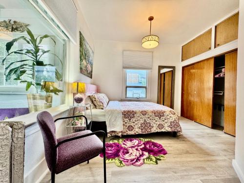 a bedroom with a bed and a table at 2nd Floor House with 2 Queen Bedrooms and Extra Sofa Bed Located 10 minutes from SeaTac Airport and 20 minutes from Downtown Seattle in Seattle