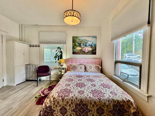 a bedroom with a bed and a large window at 2nd Floor House with 2 Queen Bedrooms and Extra Sofa Bed Located 10 minutes from SeaTac Airport and 20 minutes from Downtown Seattle in Seattle
