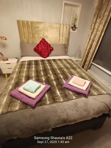 a bedroom with a bed with two pillows on it at Shauna's house in Poole