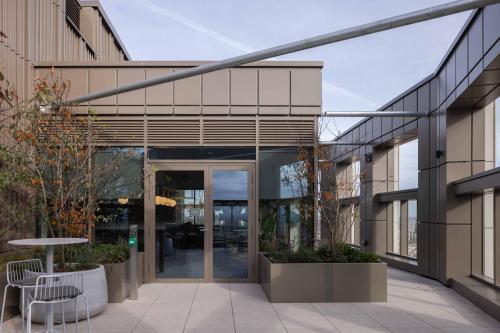 an office building with glass doors and a courtyard at StayCozy Studio Apartments in Acton in London