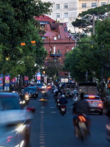 a busy city street filled with cars and motorcycles at Banla Boutique Hotel in Da Lat