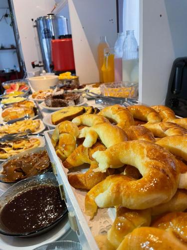 a table topped with lots of different types of pretzels at Hotel Pleno Sol in Villa Gesell