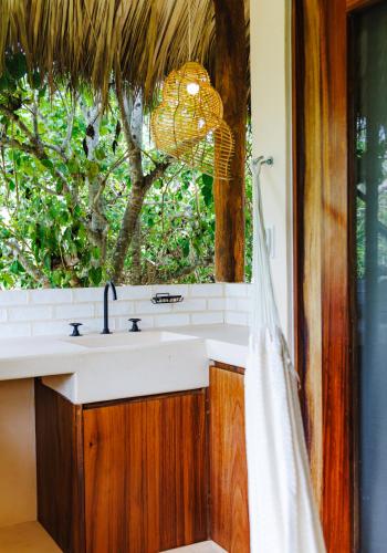a bathroom with a sink and a window at Villas Indigo Troncones in Troncones