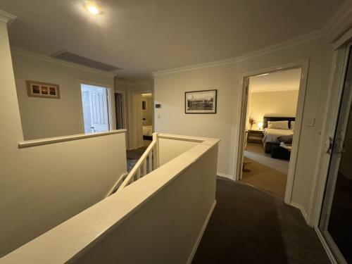 a hallway with a stairway leading to a bedroom at Beach Haven in Bunbury