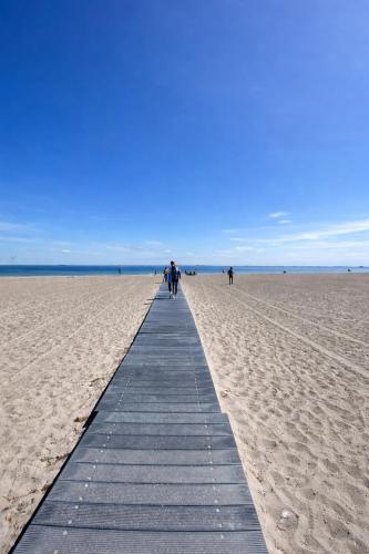 a boardwalk in the middle of a sandy beach at Danish style apartment in Copenhagen