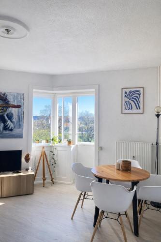 a living room with a wooden table and chairs at Danish style apartment in Copenhagen