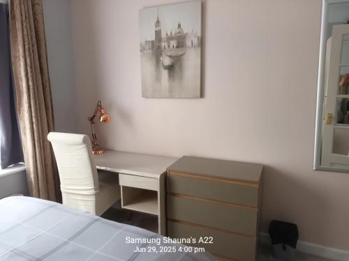 a bedroom with a desk with a chair and a bed at Shauna's house in Poole