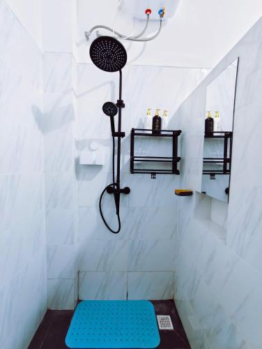 a shower with a blue bench in a bathroom at Joy Pool House in Kuta