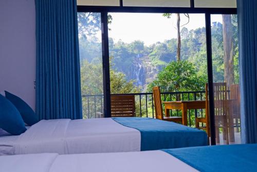 a bedroom with two beds and a balcony with a view at Ella Breathing Space in Ella