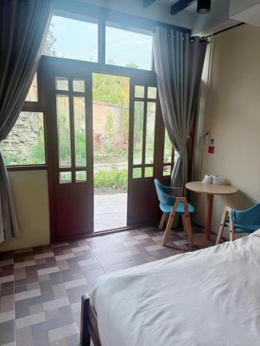 a bedroom with a bed and a table and chairs at Hidden Valley Pai in Pai