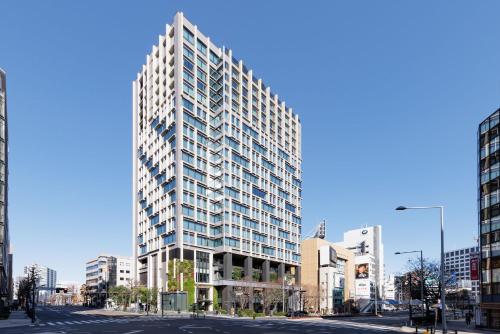 a rendering of a tall building in a city at THE AOYAMA GRAND HOTEL in Tokyo