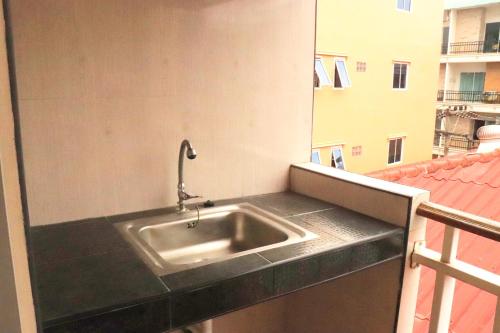 a sink on the side of a balcony at Rouge Service Apartments, Soi Buakhao in Pattaya