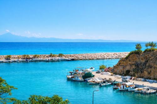 a group of boats docked in a body of water at Star Bay Luxury in Limenaria