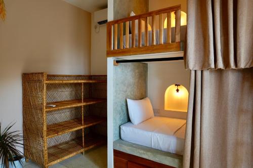 a bedroom with a bunk bed and a bunk room with a bunk bed at Dreamers Surf House in Matara