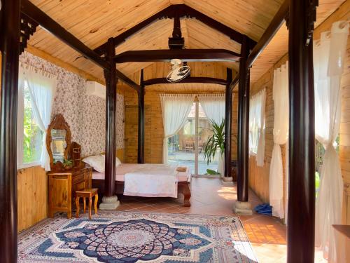a bedroom with a bed and a table in a room at Homestay Vườn Của Gió in Ấp Thanh Sơn (1)