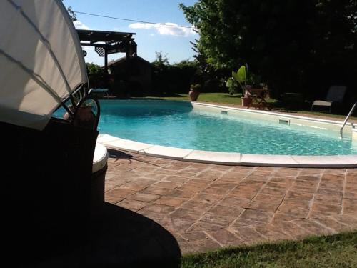 a bench sitting next to a swimming pool at Casa la Quiete in Torgiano