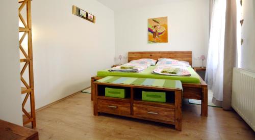 a bedroom with a bed and a wooden table at Appartement Veronika in Öblarn