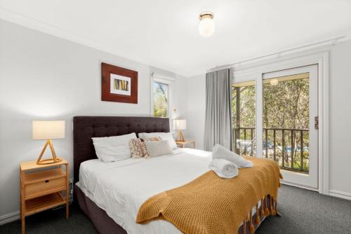 a bedroom with a large bed and a window at Three Bears 3 - Thredbo in Thredbo