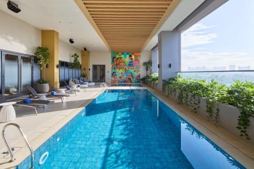a swimming pool in a hotel with a view at Alino Hotel in Manila
