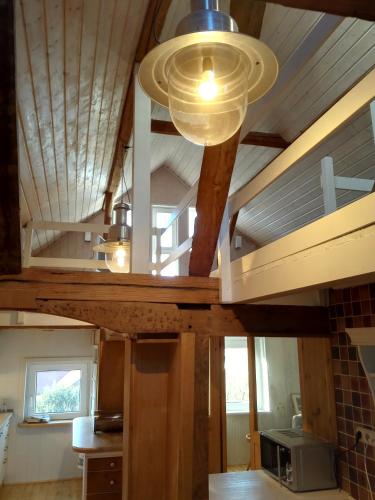 a kitchen with a vaulted ceiling with a microwave at Ferienhaus Landhaus Am Hirtzborn in Marburg an der Lahn