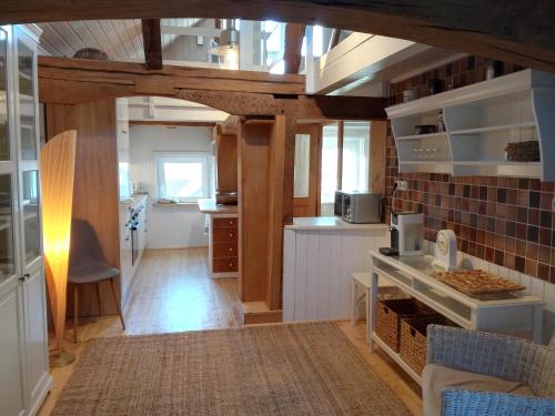 a kitchen with white cabinets and a counter top at Ferienhaus Landhaus Am Hirtzborn in Marburg an der Lahn