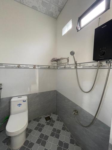 a bathroom with a toilet and a shower at Town Homestay in Thôn Sơn Hải