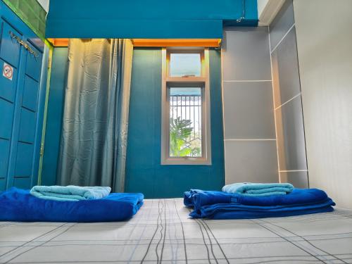 a room with two blue pillows on the floor at Pintu Biru Hostel in Wamena