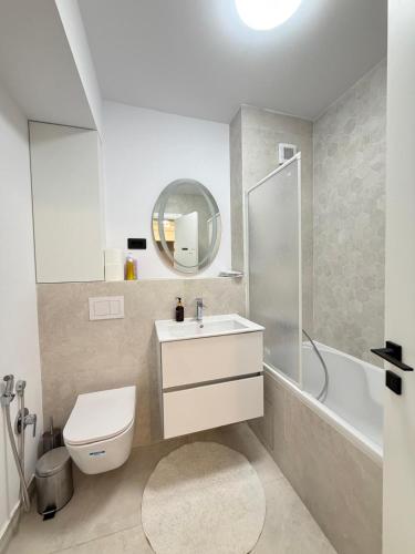 a bathroom with a toilet and a sink and a shower at Old Town Vinyl Retreat near the Cathedral with retro vibes in Iaşi