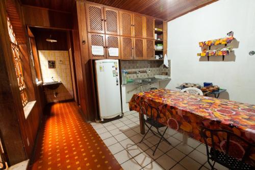 a kitchen with a table and a refrigerator at Hostel Amazonia in Belém