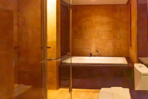 a bathroom with a shower and a sink and a toilet at Boracay Sands Hotel in Boracay